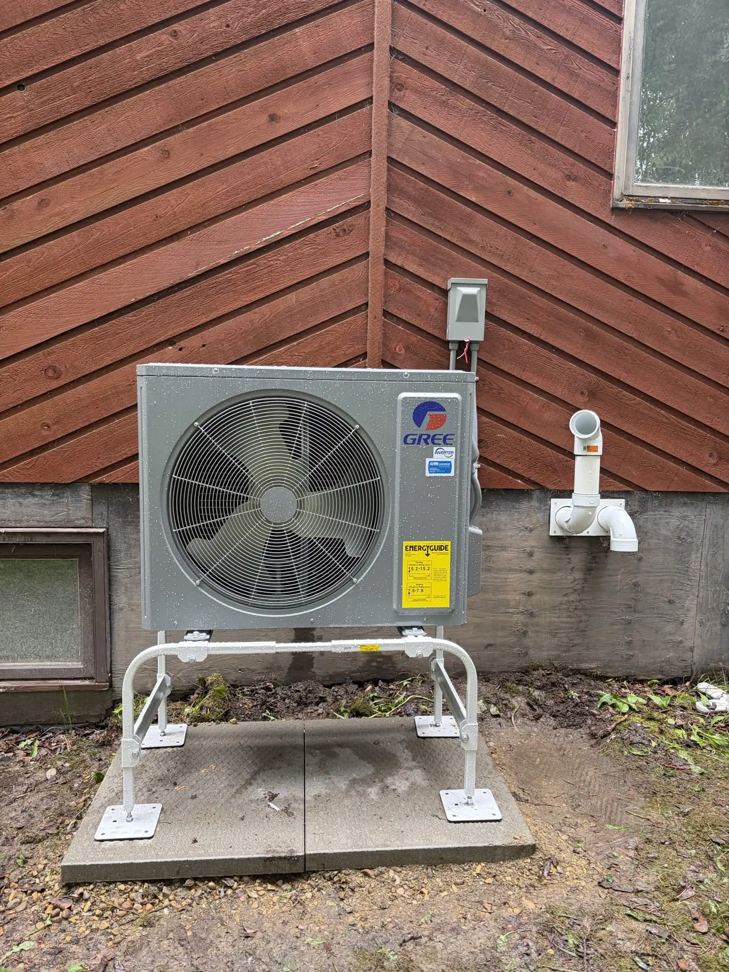 Gree cold-climate heat pump installed on a raised equipment stand